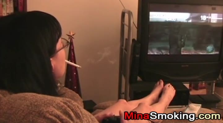 Gaming girlfriend smokes a cigarette