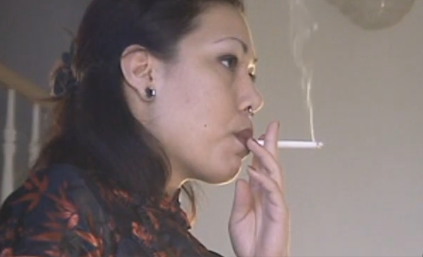 Attractive woman loves to please her smoking habit