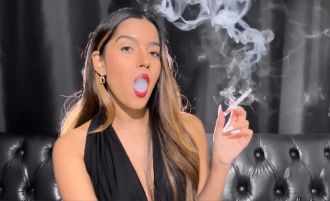 Applying lipstick and smoking a white ciggie – Angie