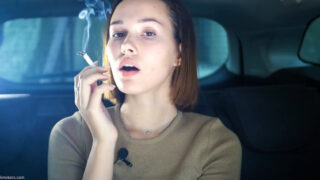Beautiful Yulia is smoking with only nose exhales in the car