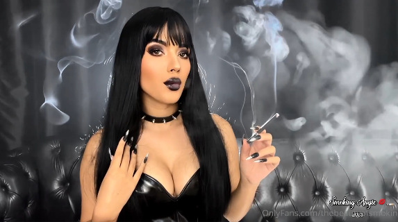 Brunette bimbo smoking black cigarette in a leather top – Angie