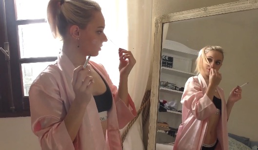 Chloe chainsmoking in front of mirror