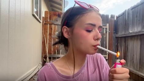 Cute girl smoking in the porch