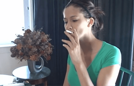 Girl smoking playing cards with dangle