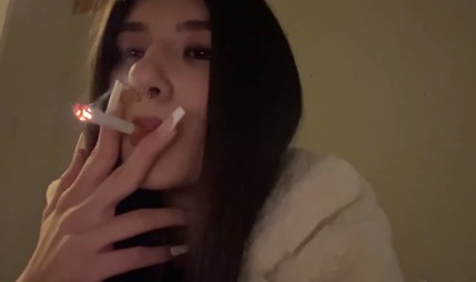 Italian brunette smokes on work break