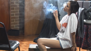 Katie smokes two Cigarettes in a Marlboro shirt
