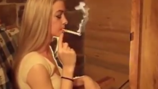 Long haired blonde smokes a Red 100 to the filter