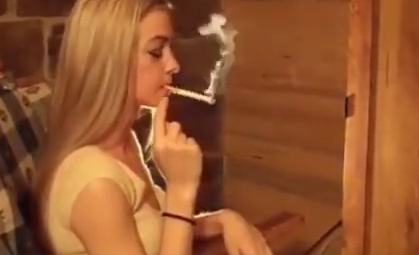 Long haired blonde smokes a Red 100 to the filter
