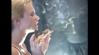 This Chick is Smoking Two Cigars at once and Inhaling all the smoke