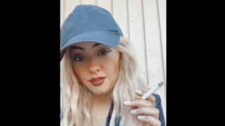 Skittlez smoking with baseball cap