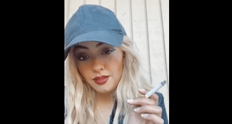 Skittlez smoking with baseball cap