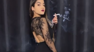 Smoking in a black minidress – Angie
