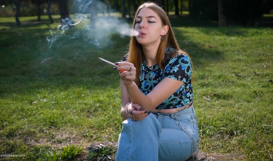 Sweet Svetlana is smoking two all white cigarettes