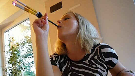 Woman smoking 3 cigarettes at once with holder